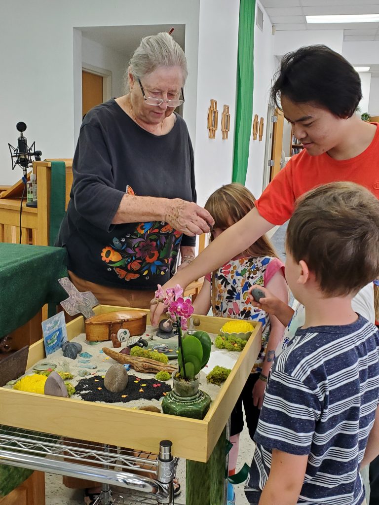 Sunday School children with Japanese garden display during Season of Creation.