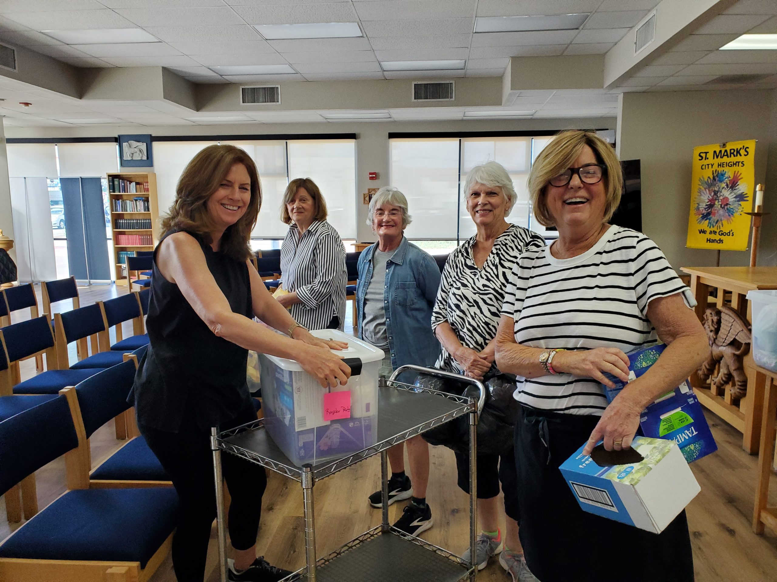 group of 5 volunteers assembling hygiene packs