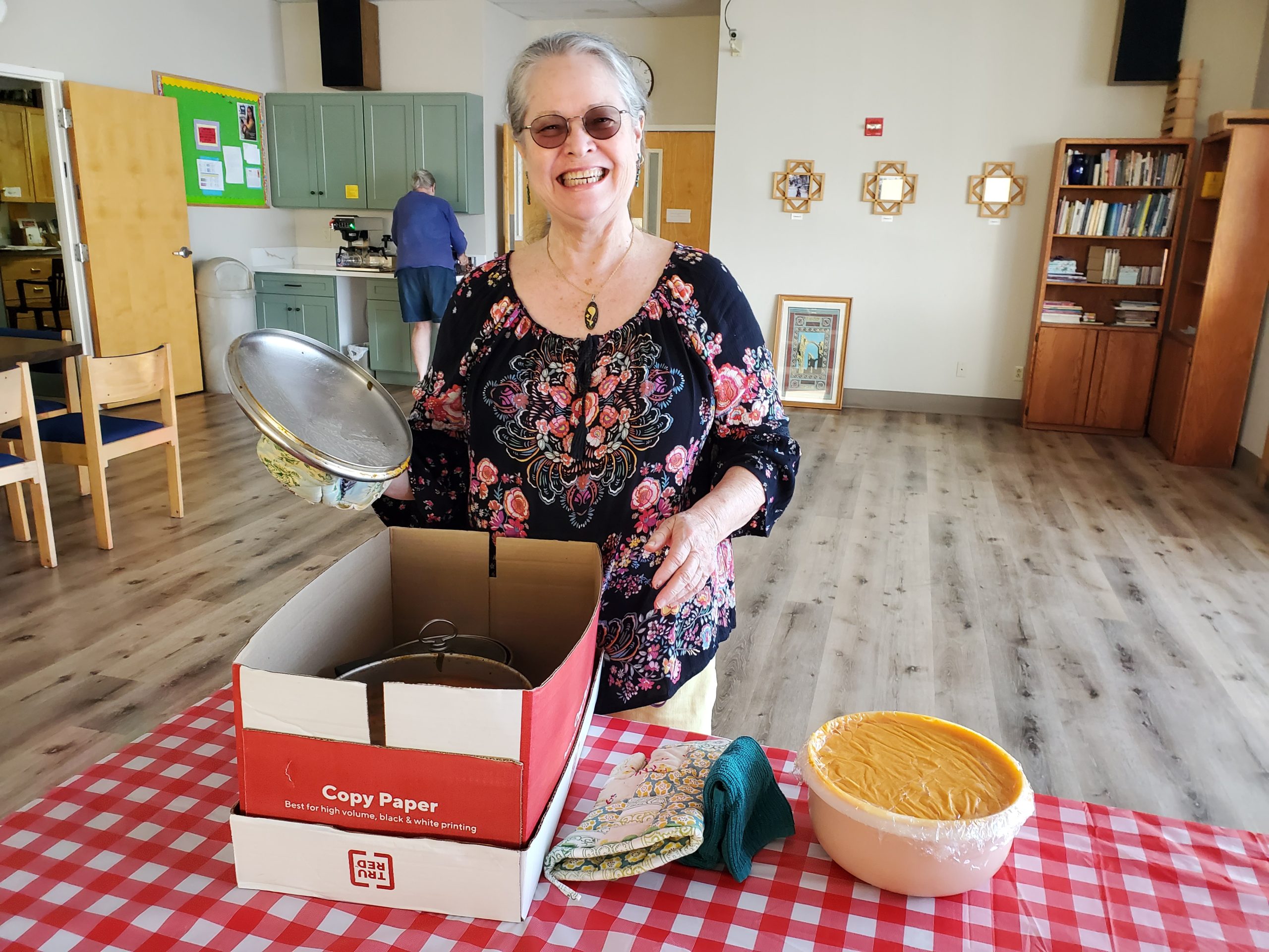 Debbie Kistler setting dishes she prepared for Stations of the Cross soup supper on the table.